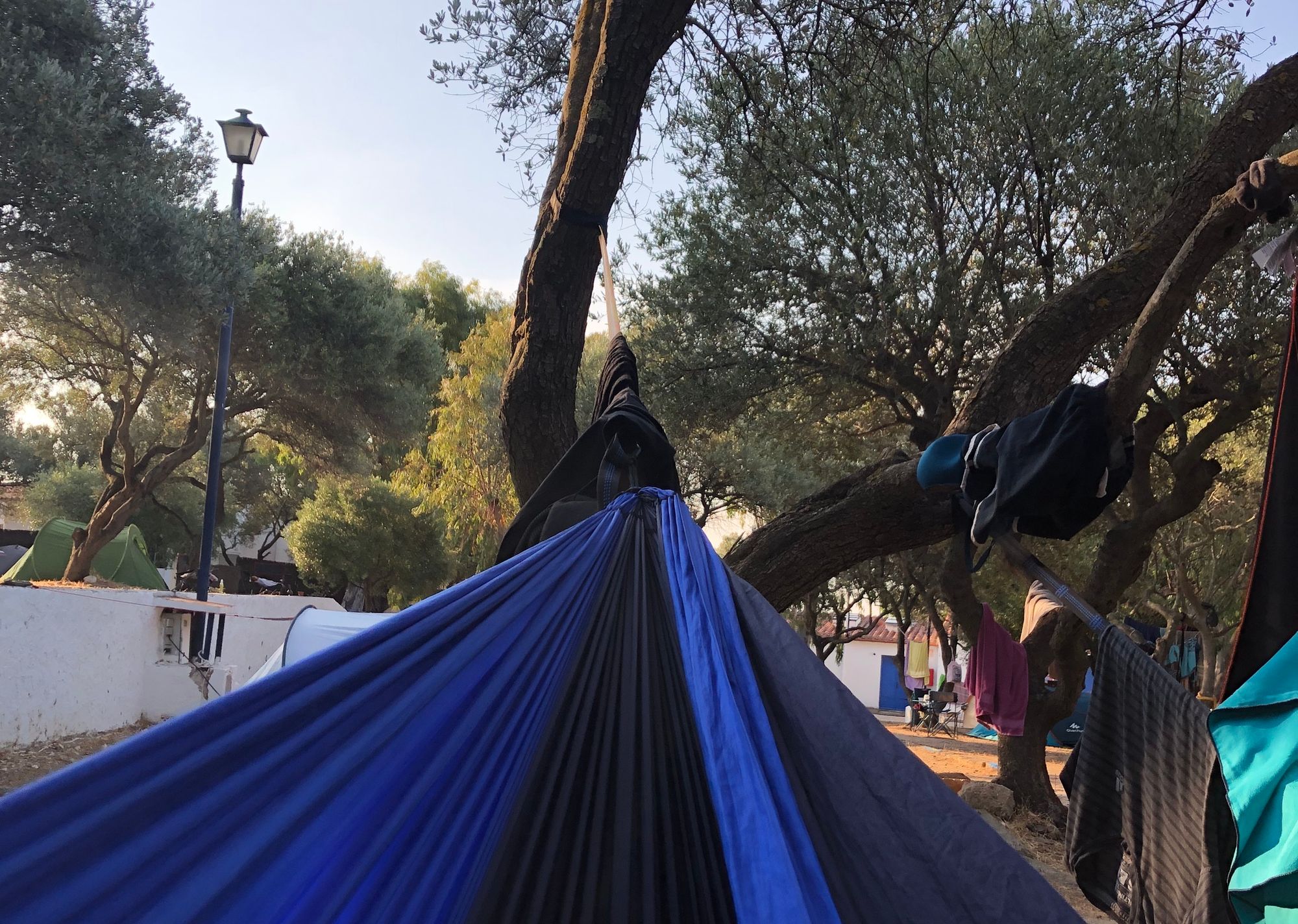First person point of view from a hammock tied to a tree camping in cadaques